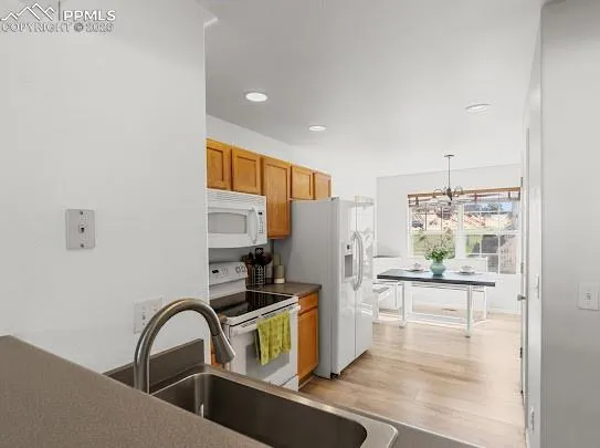 a kitchen with stainless steel appliances a refrigerator and a stove top oven