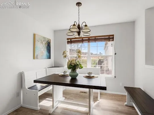a view of a dining room with furniture and chandelier