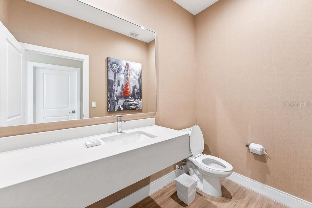 3119 Rockefeller Way Kissimmee, FL 34747 - Photo 15 of 57 a bathroom with a sink a toilet and mirror