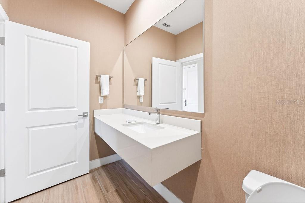 3119 Rockefeller Way Kissimmee, FL 34747 - Photo 16 of 57 a bathroom with a sink vanity and a mirror
