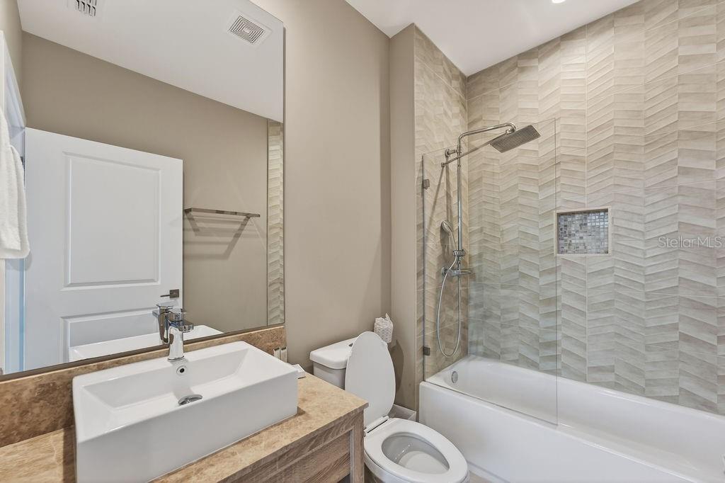 3119 Rockefeller Way Kissimmee, FL 34747 - Photo 24 of 57 a bathroom with a sink a toilet and shower