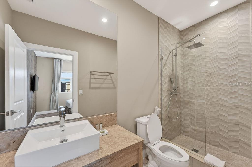 3119 Rockefeller Way Kissimmee, FL 34747 - Photo 28 of 57 a bathroom with a sink a toilet and shower