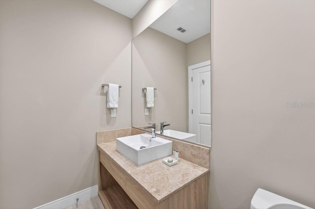 3119 Rockefeller Way Kissimmee, FL 34747 - Photo 29 of 57 a bathroom with a sink and a mirror