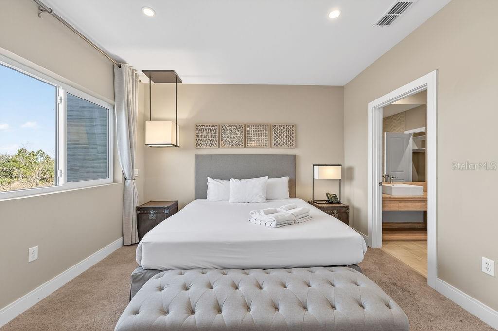 3119 Rockefeller Way Kissimmee, FL 34747 - Photo 32 of 57 a bedroom with a large bed and a window