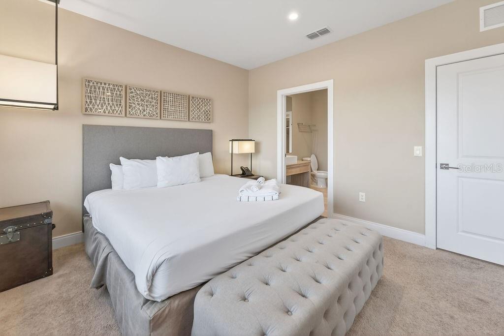 3119 Rockefeller Way Kissimmee, FL 34747 - Photo 33 of 57 a bedroom with a bed and a night stand