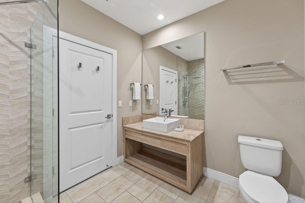 3119 Rockefeller Way Kissimmee, FL 34747 - Photo 37 of 57 a bathroom with a toilet a sink and mirror