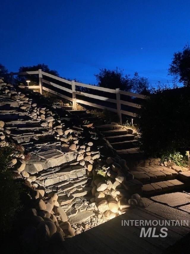 40 Bell Rapids Road Hagerman, ID 83332 - Photo 48 of 50 Terraced stone steps with integrated path lighting and a white three-rail fence