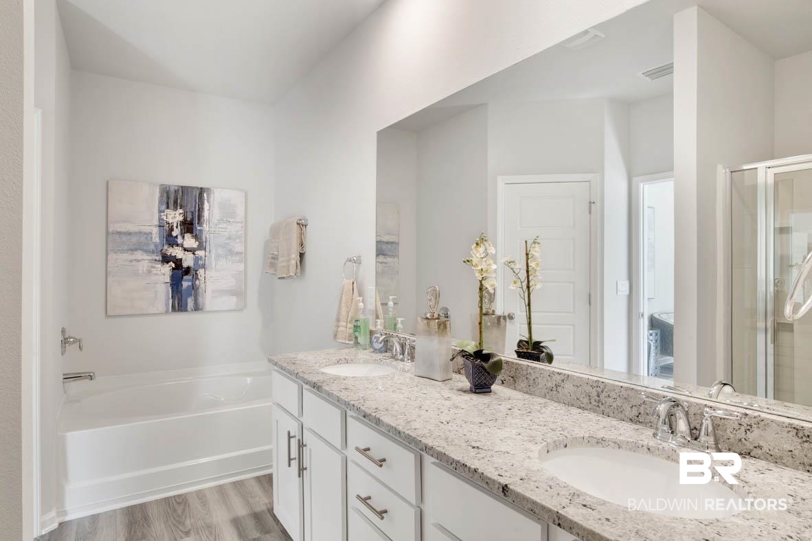 13822 Antler Hl Road Daphne, AL 36527 - Photo 34 of 39 Bathroom featuring vanity, hardwood / wood-style flooring, and separate shower and tub