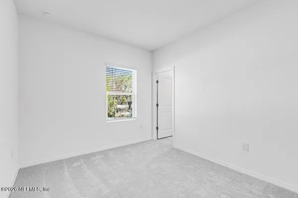 a bedroom with a bed and a mirror