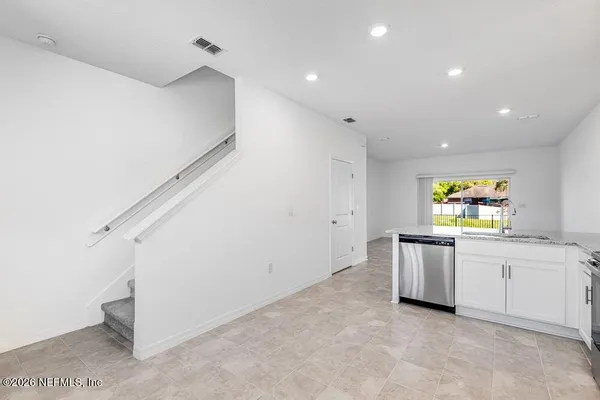 a view of kitchen with window and stainless steel appliances