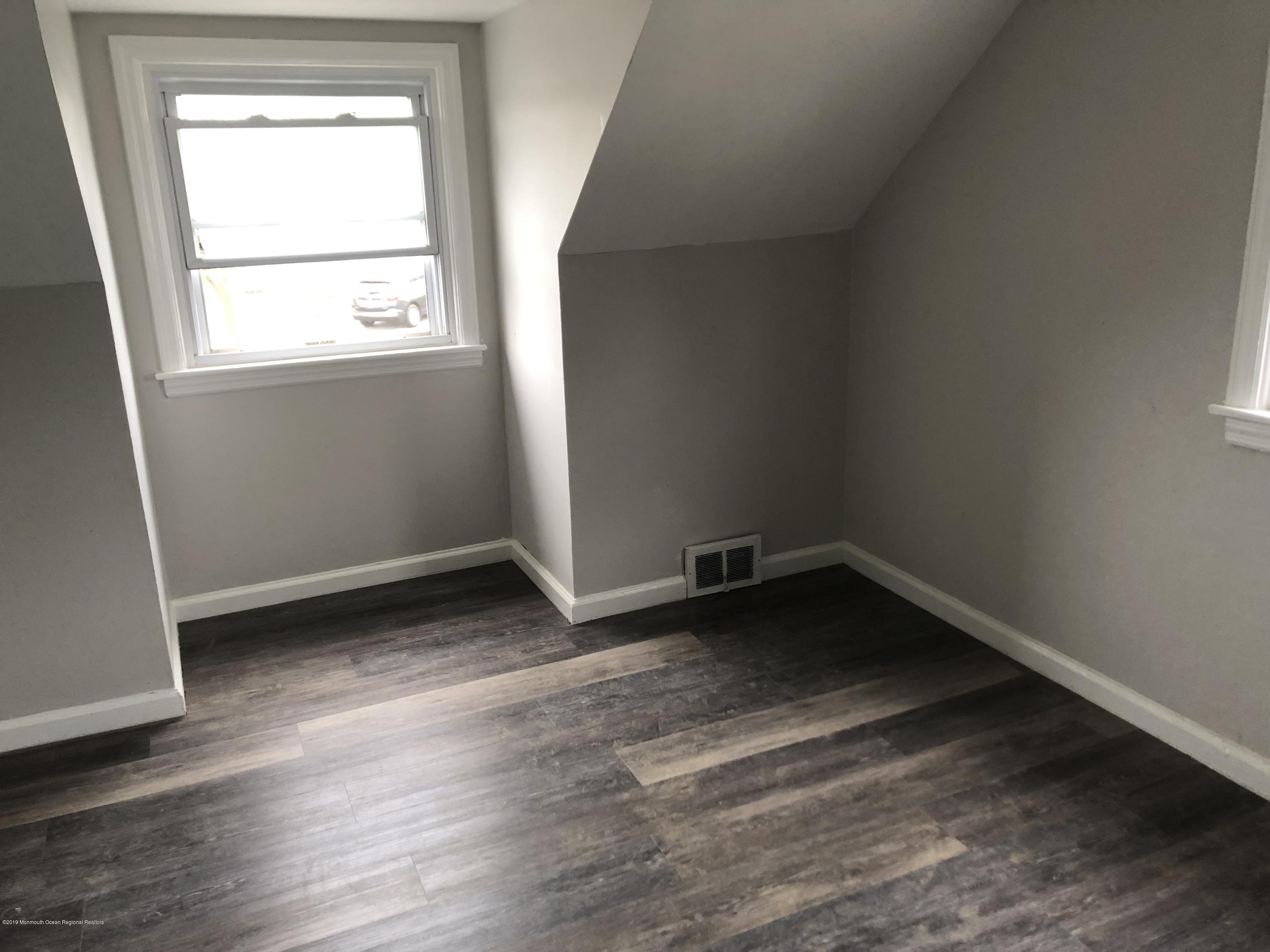 49 Ridge Place Neptune City, NJ 07753 - Photo 6 of 9 an empty room with a window