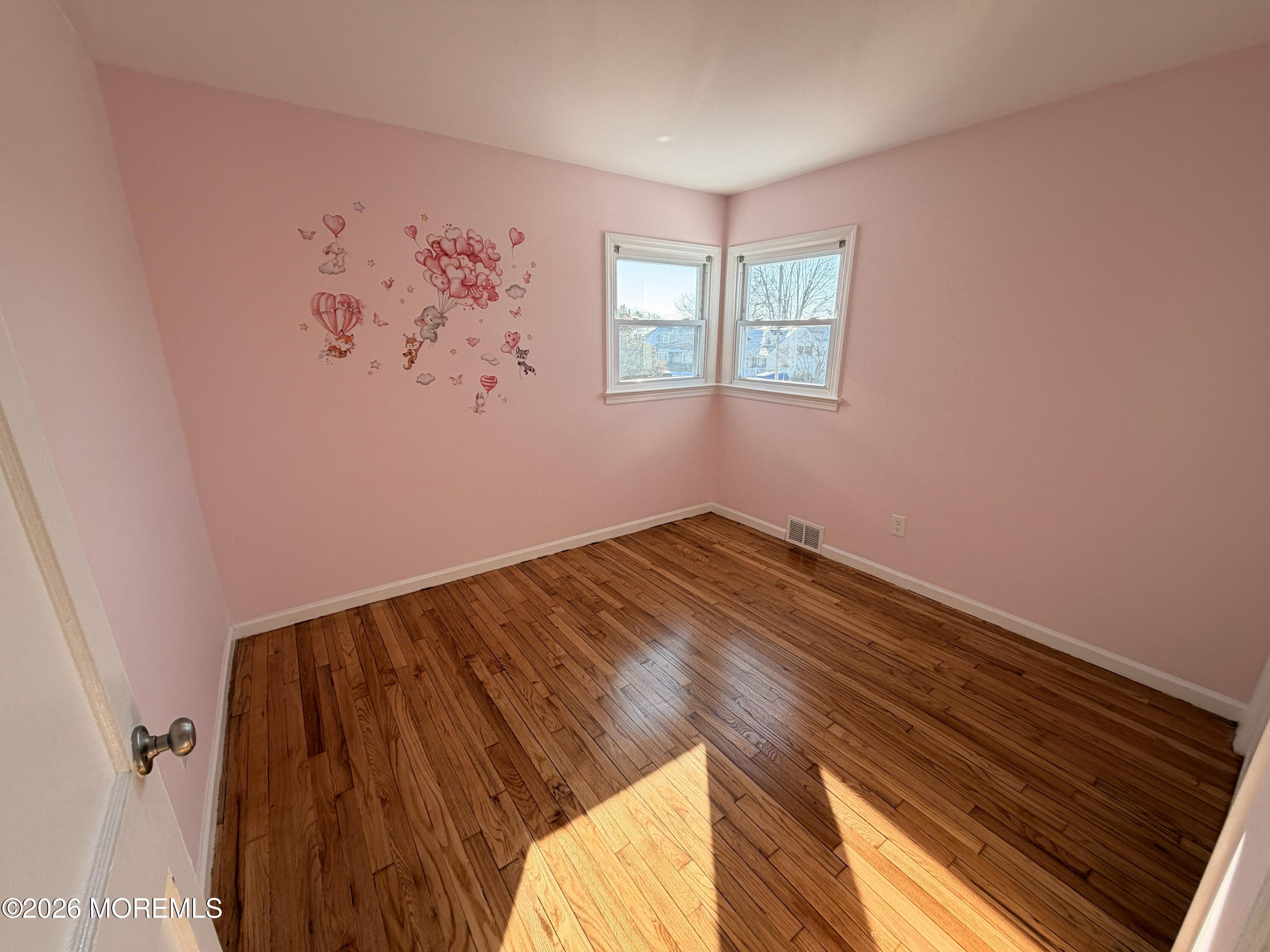 49 Ridge Place Neptune City, NJ 07753 - Photo 8 of 9 a view of a room with wooden floor and wall painting