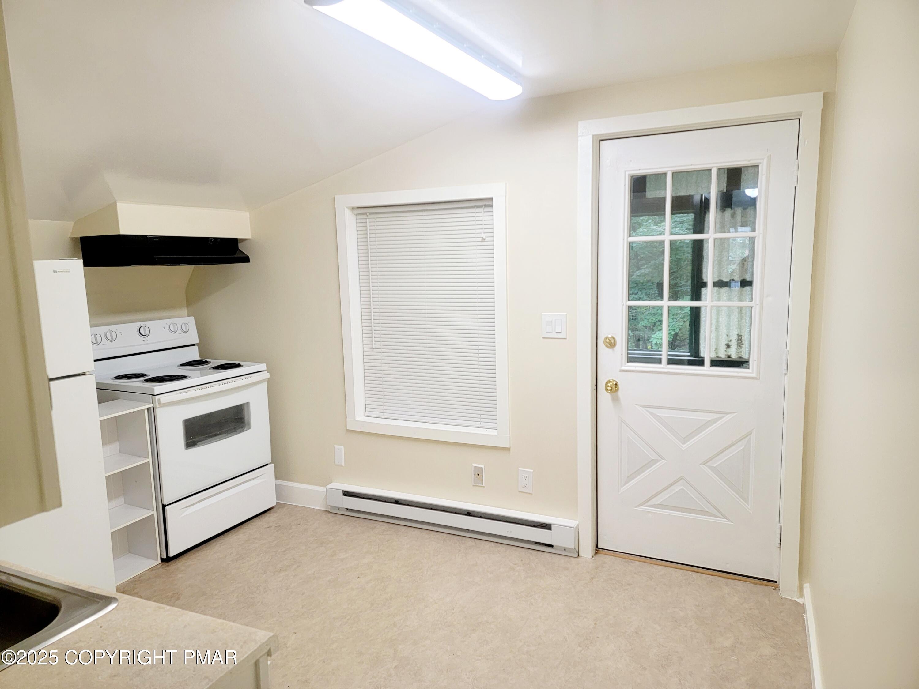 122 Maggie Way, Unit 202 Effort, PA 18330 - Photo 3 of 5 a kitchen with white cabinets and white appliances