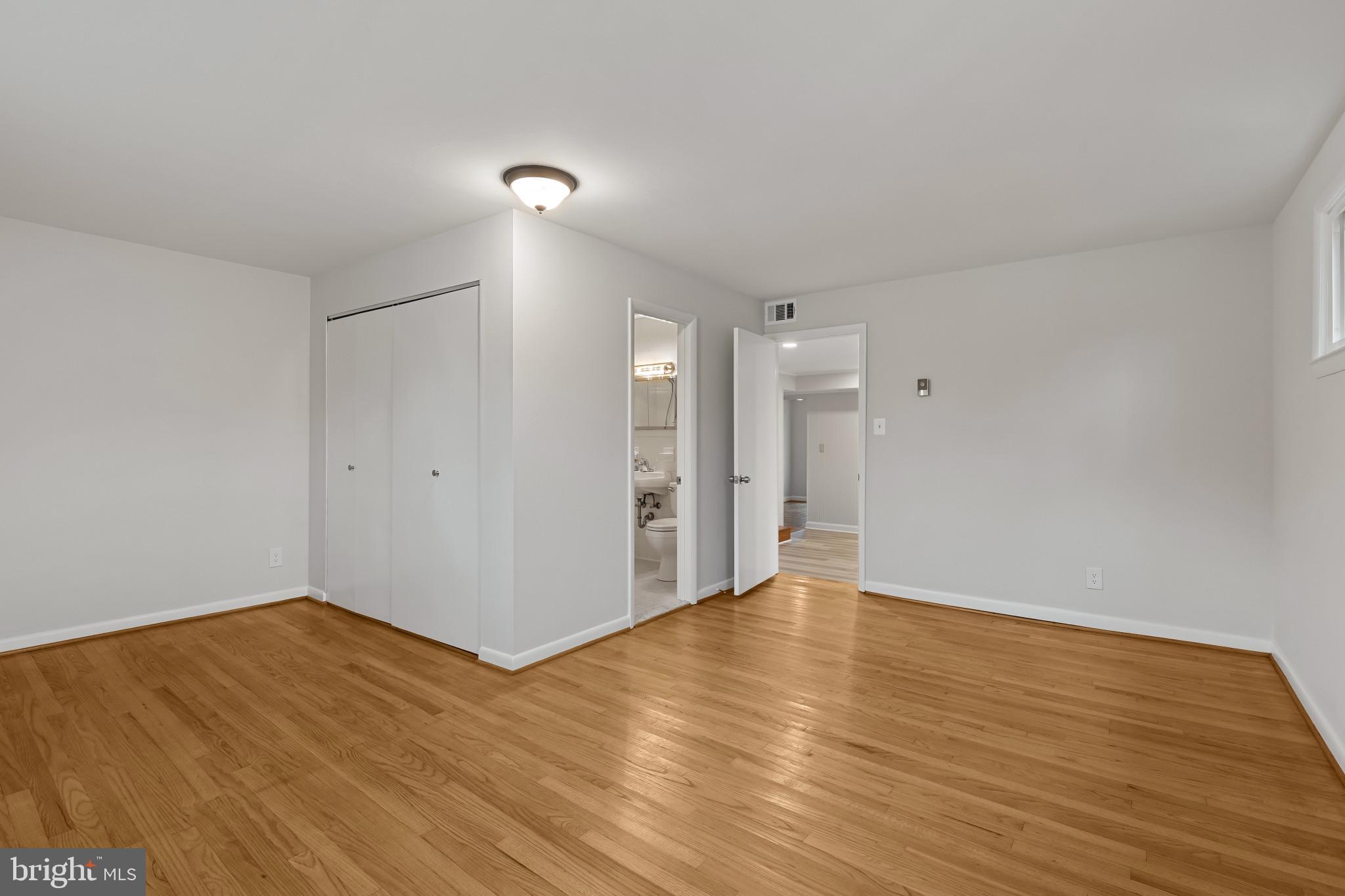 302 Wessling Circle Baltimore, MD 21228 - Photo 11 of 41 a view of an empty room with wooden floor and a window