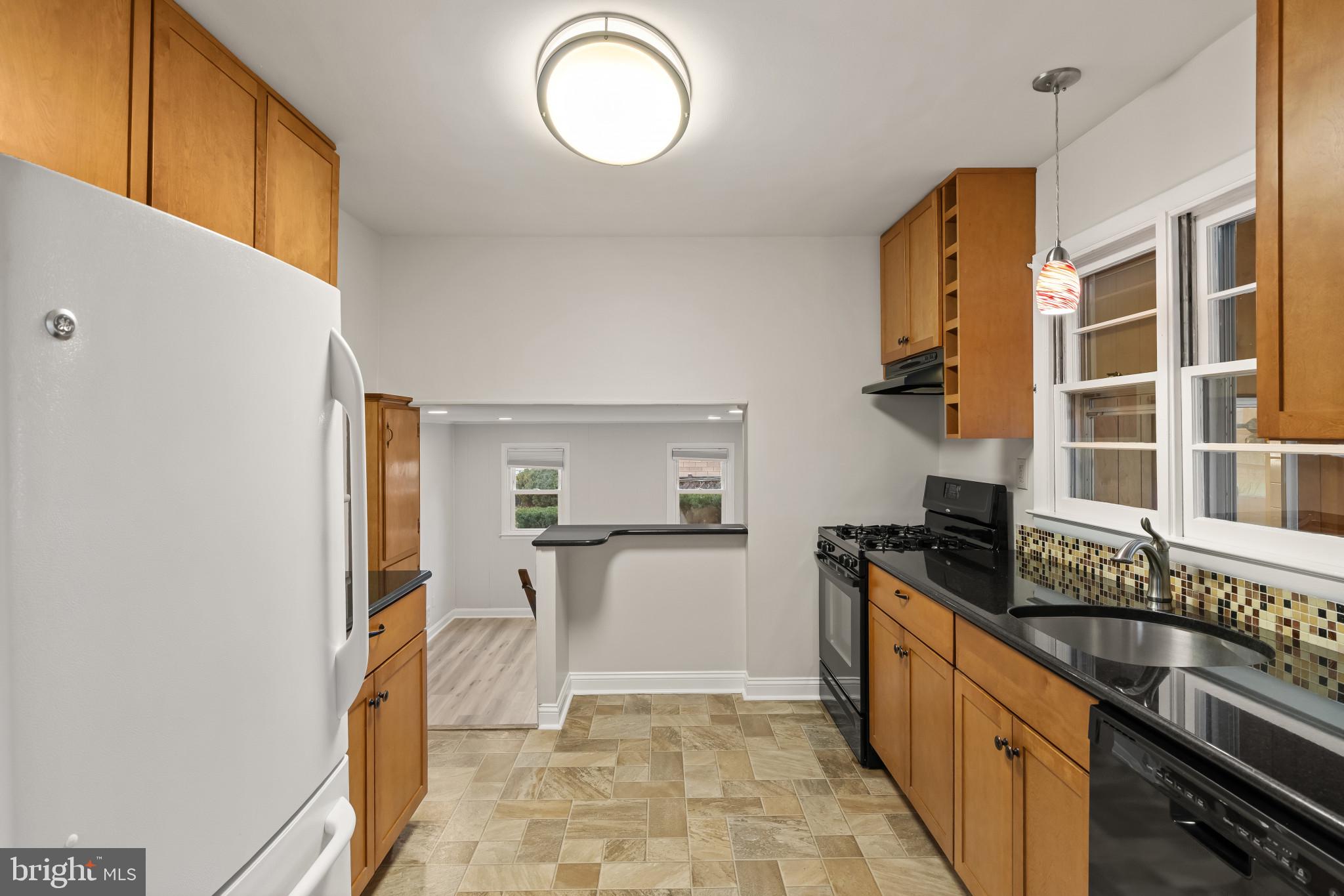 302 Wessling Circle Baltimore, MD 21228 - Photo 16 of 41 a kitchen with granite countertop a sink and a stove top oven