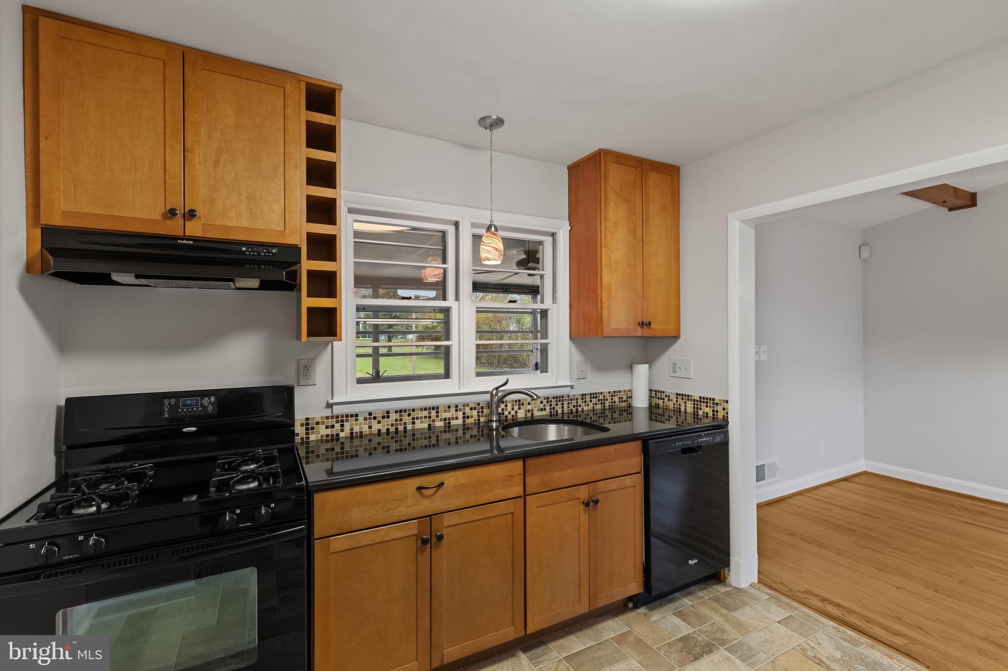 302 Wessling Circle Baltimore, MD 21228 - Photo 18 of 41 a kitchen with a sink stove and microwave