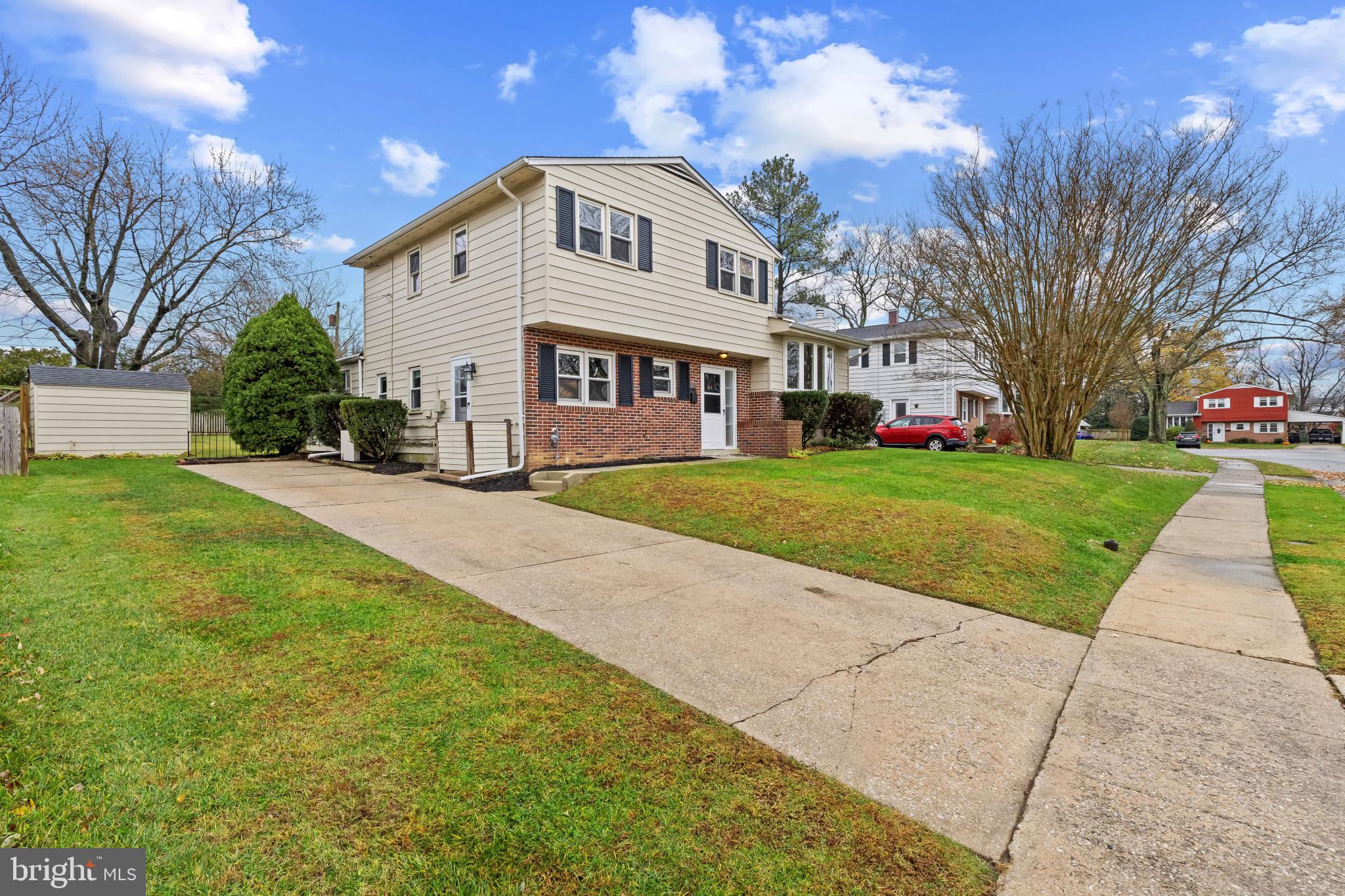 302 Wessling Circle Baltimore, MD 21228 - Photo 2 of 41 a view of a white house with a big yard and large trees