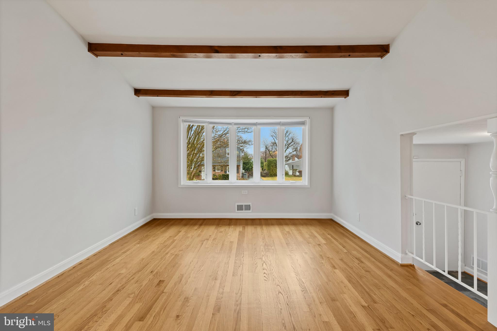 302 Wessling Circle Baltimore, MD 21228 - Photo 21 of 41 a view of an empty room with wooden floor and a window