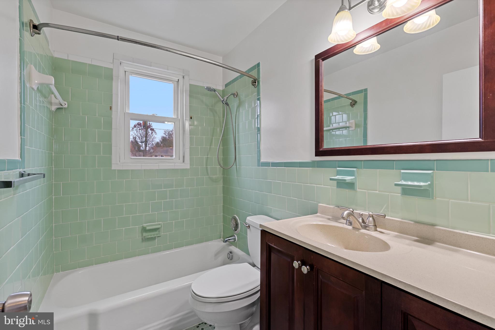 302 Wessling Circle Baltimore, MD 21228 - Photo 30 of 41 a bathroom with a toilet a sink and mirror