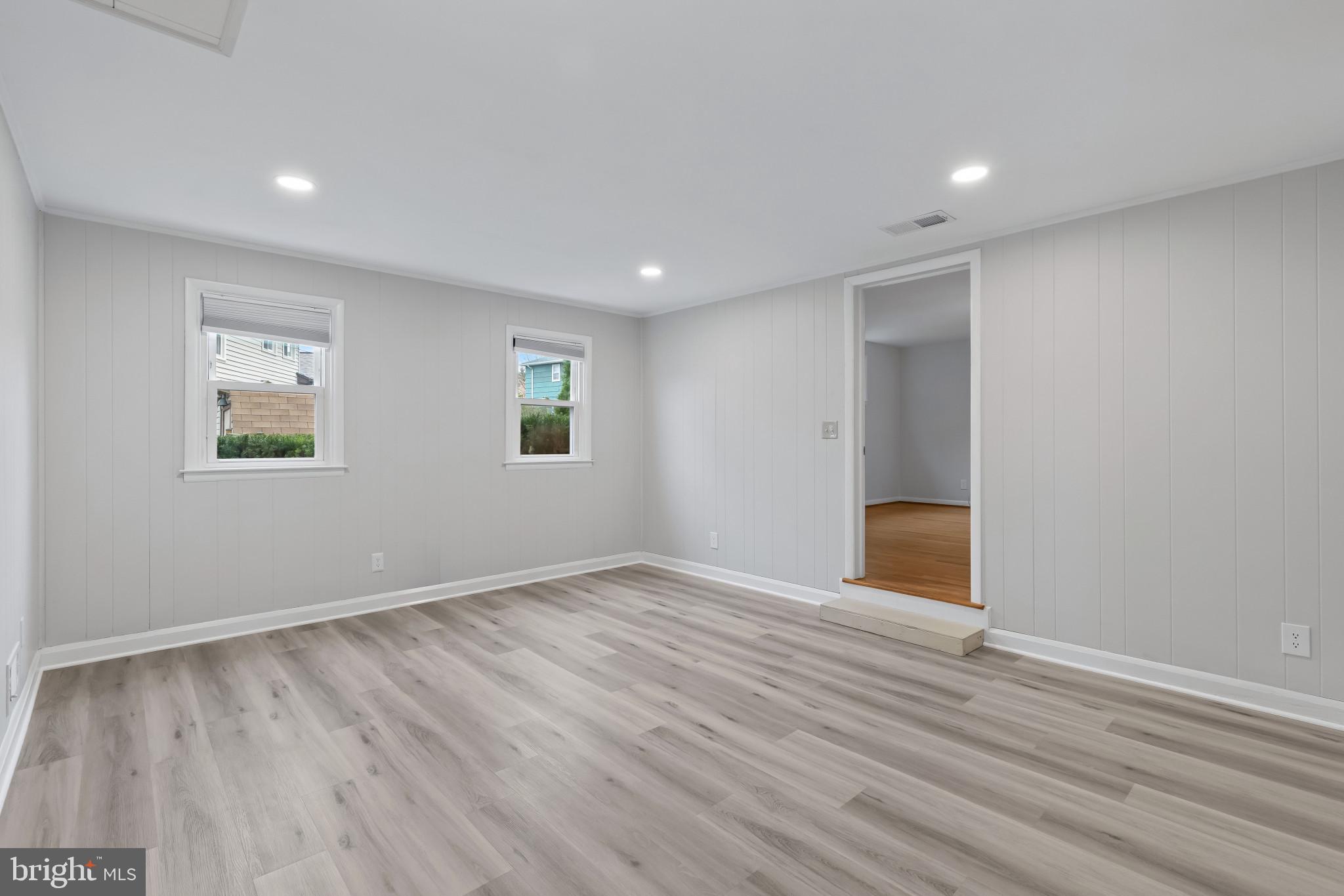 302 Wessling Circle Baltimore, MD 21228 - Photo 8 of 41 a view of an empty room with wooden floor and a window