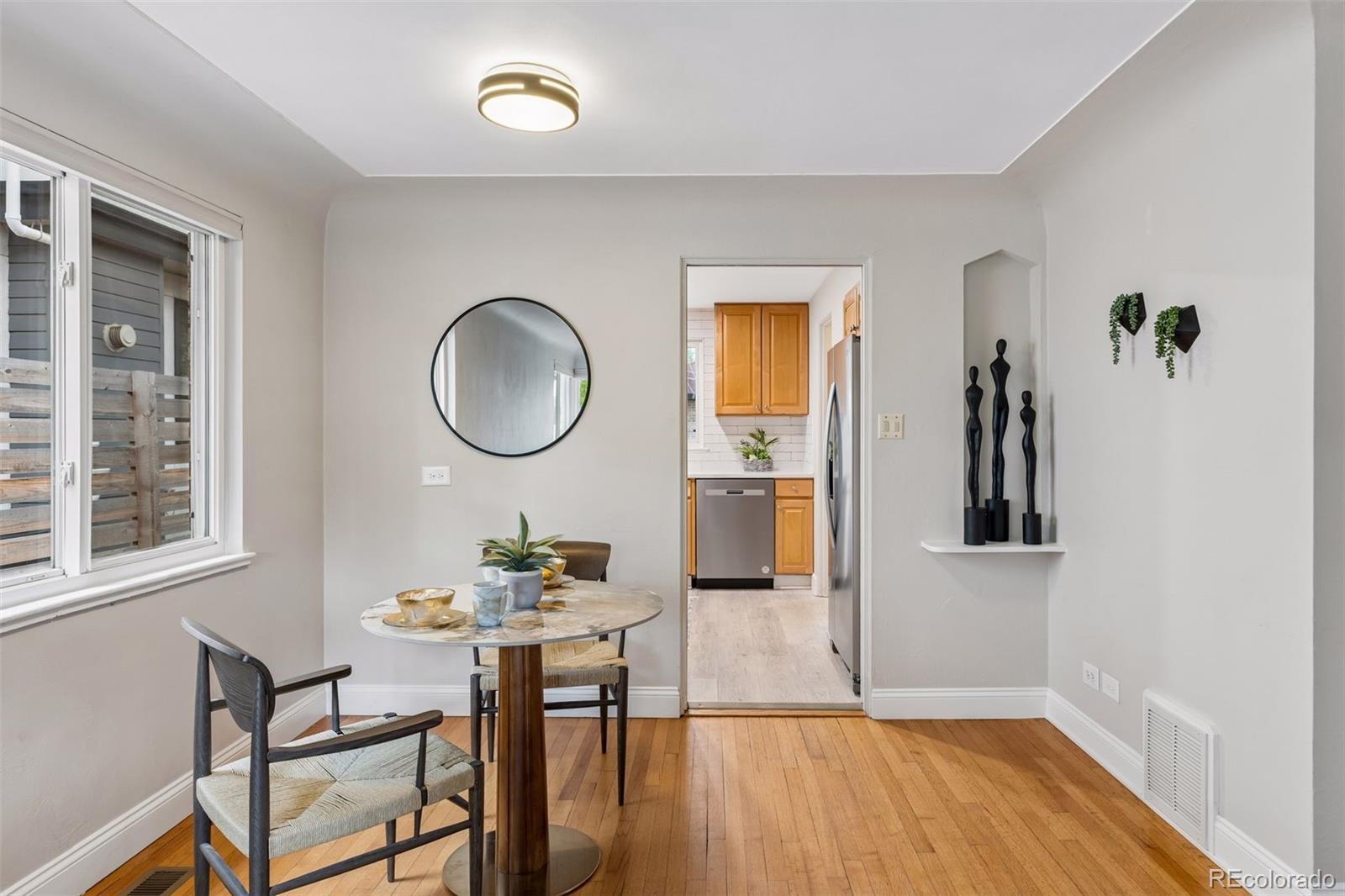 2255 Meade Street Denver, CO 80211 - Photo 7 of 30 a view of a dining room with furniture and wooden floor