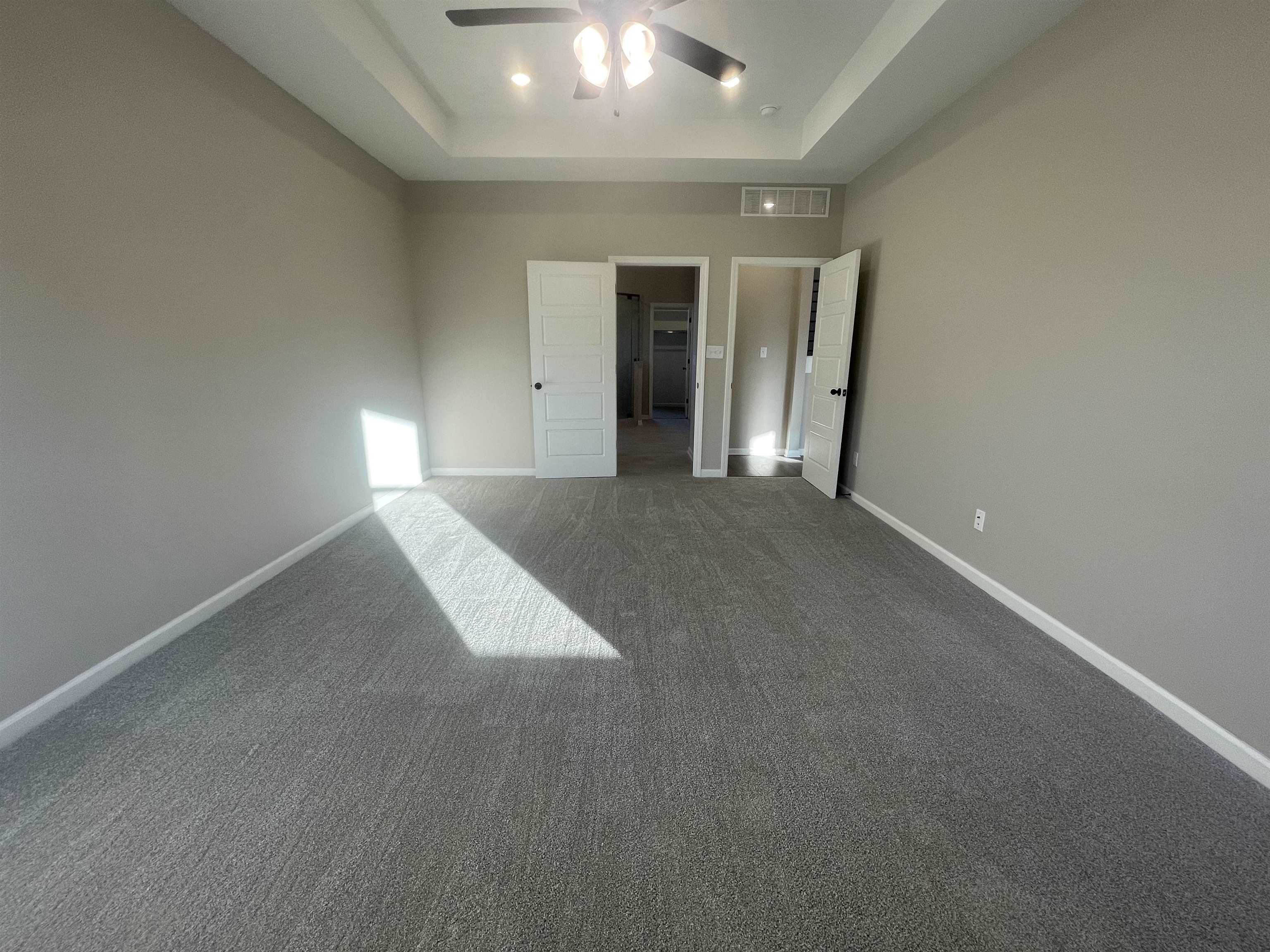 19 Columbia Way Atoka, TN 38004 - Photo 13 of 28 Unfurnished bedroom with carpet flooring, ceiling fan, and a tray ceiling