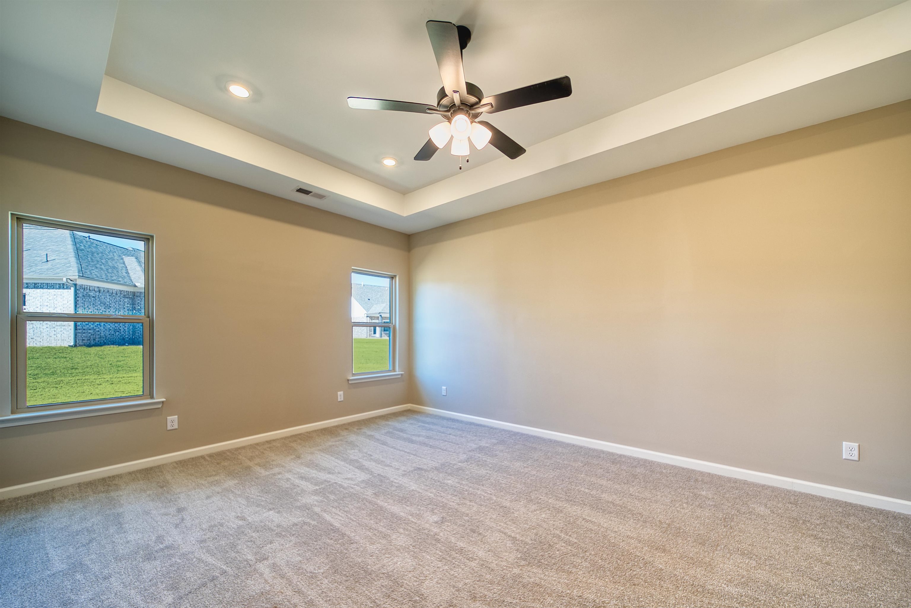 19 Columbia Way Atoka, TN 38004 - Photo 16 of 40 Carpeted empty room with a tray ceiling, recessed lighting, and ceiling fan