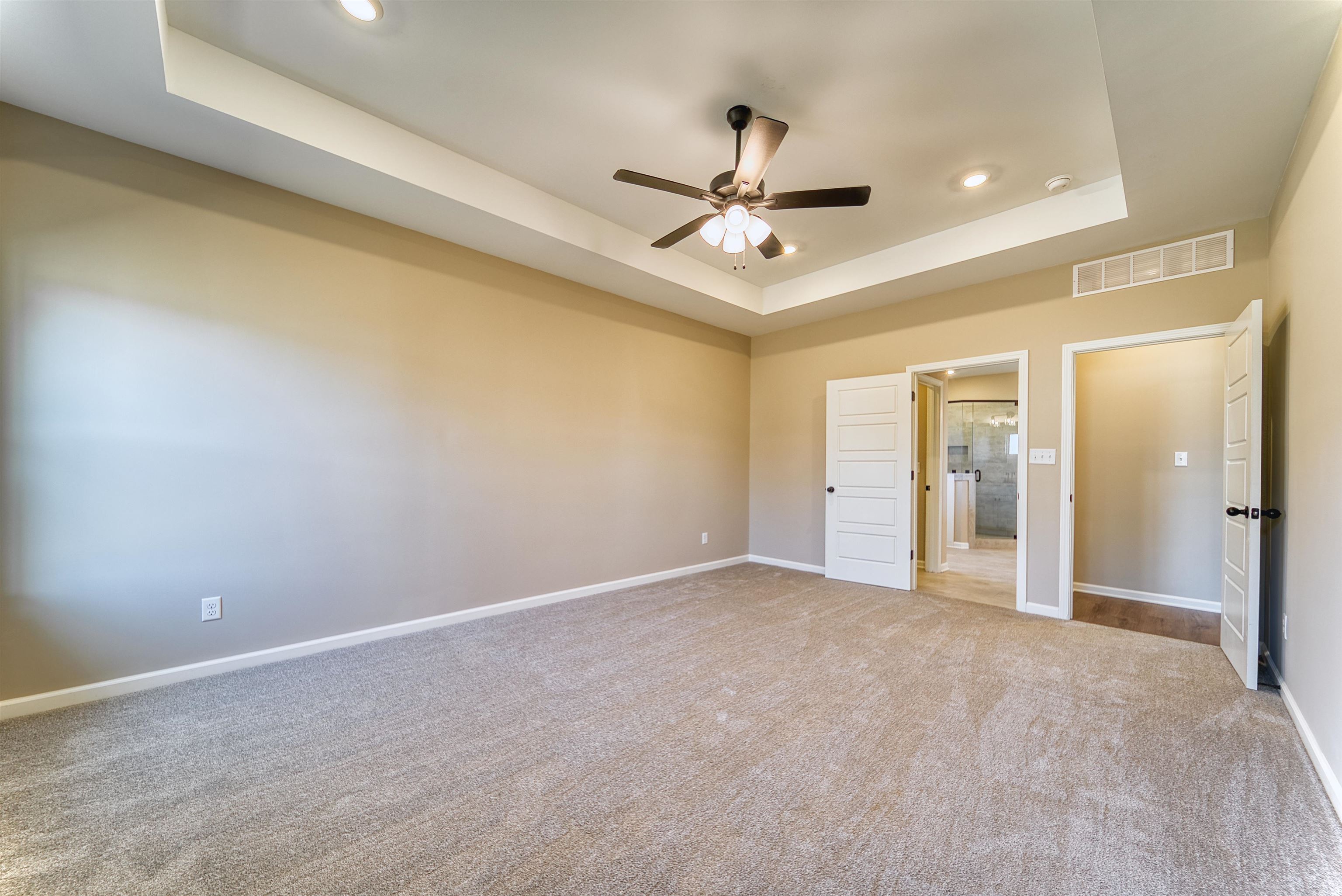 19 Columbia Way Atoka, TN 38004 - Photo 17 of 40 Unfurnished bedroom featuring a raised ceiling, carpet floors, a ceiling fan, and recessed lighting