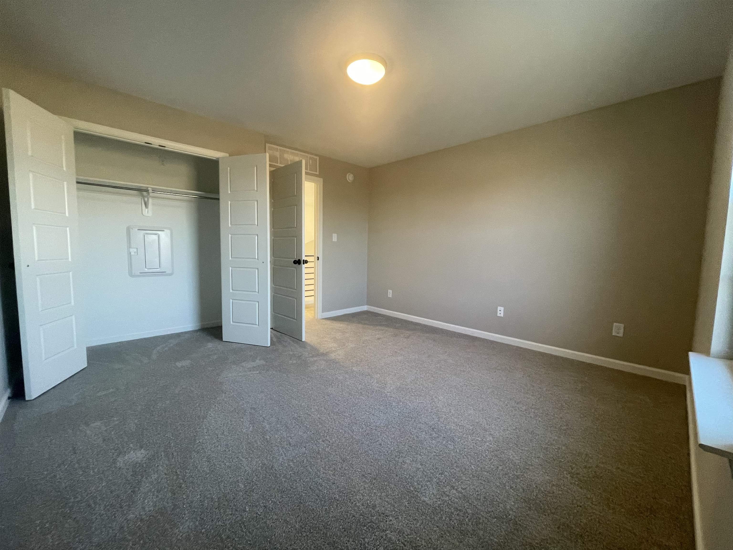 19 Columbia Way Atoka, TN 38004 - Photo 17 of 28 Unfurnished bedroom featuring dark carpet and a closet