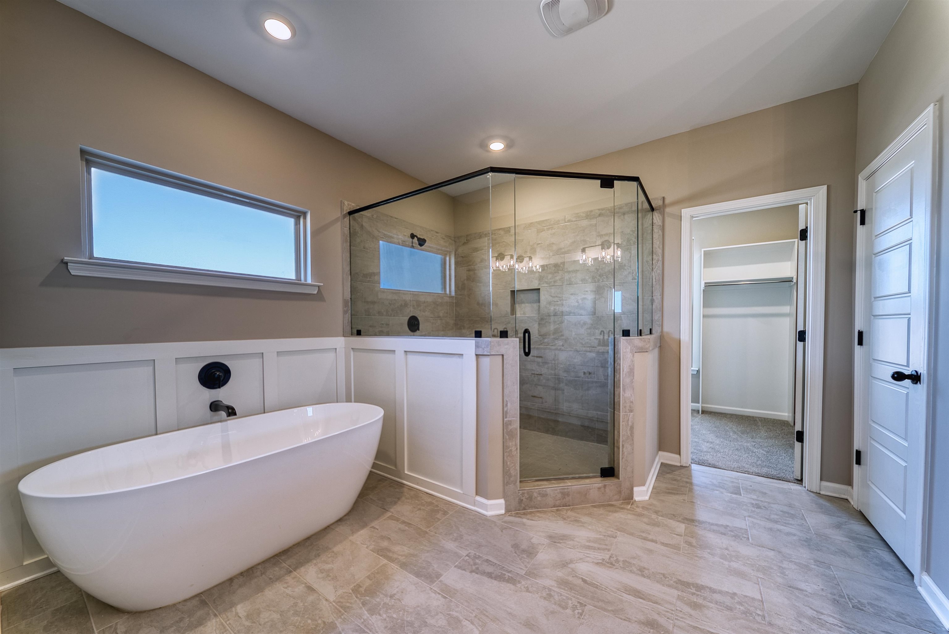 19 Columbia Way Atoka, TN 38004 - Photo 19 of 40 Full bath featuring a shower stall, a freestanding tub, and a spacious closet