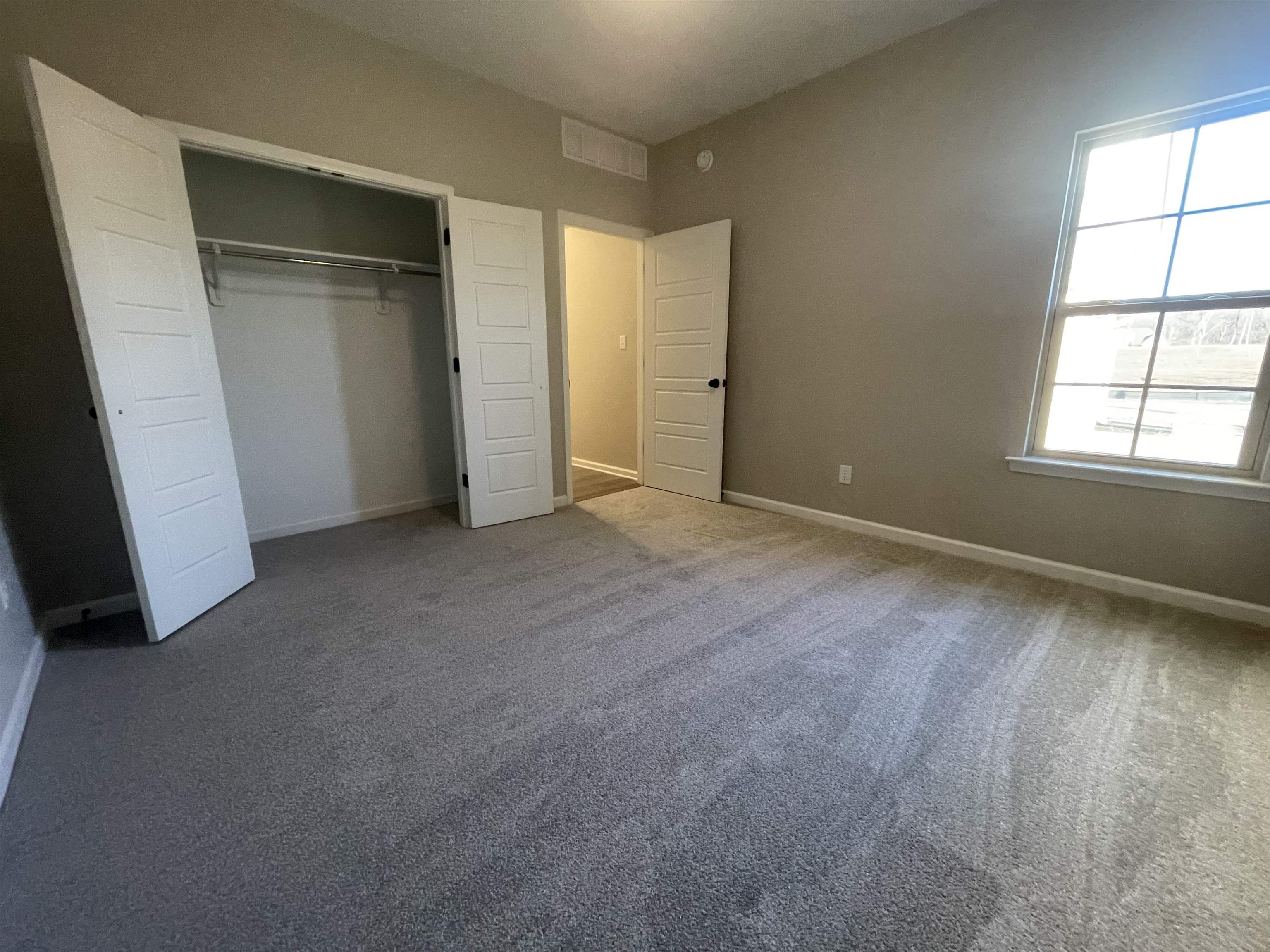 19 Columbia Way Atoka, TN 38004 - Photo 25 of 28 Unfurnished bedroom with carpet floors and a closet