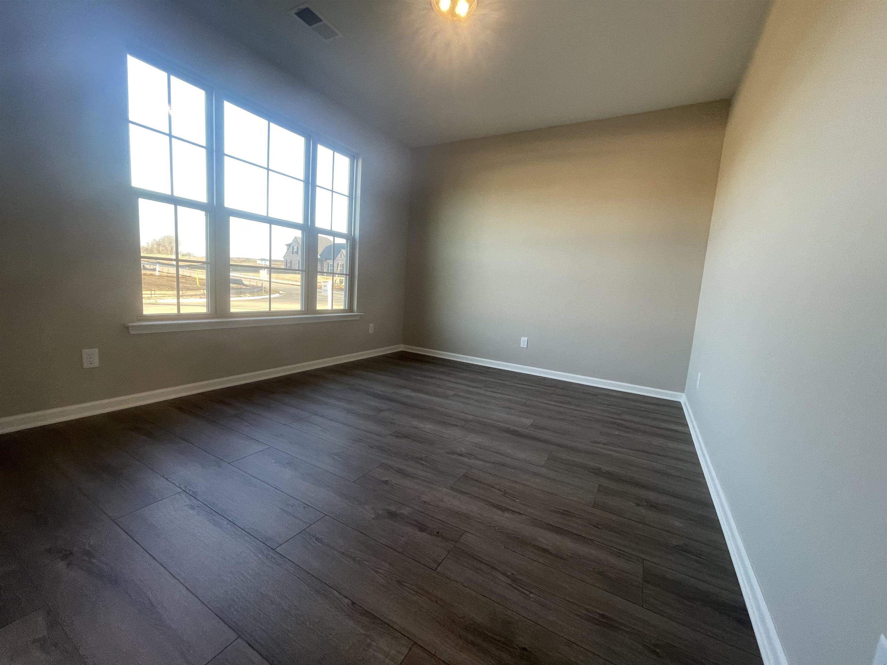 19 Columbia Way Atoka, TN 38004 - Photo 26 of 28 Empty room featuring dark wood finished floors and baseboards