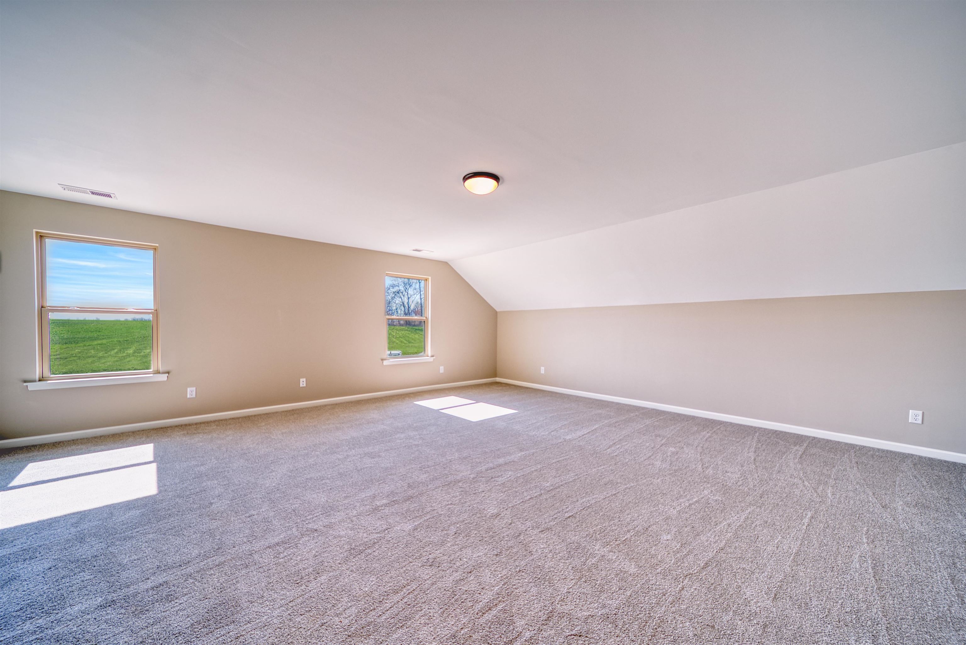19 Columbia Way Atoka, TN 38004 - Photo 30 of 40 Additional living space with vaulted ceiling and light carpet