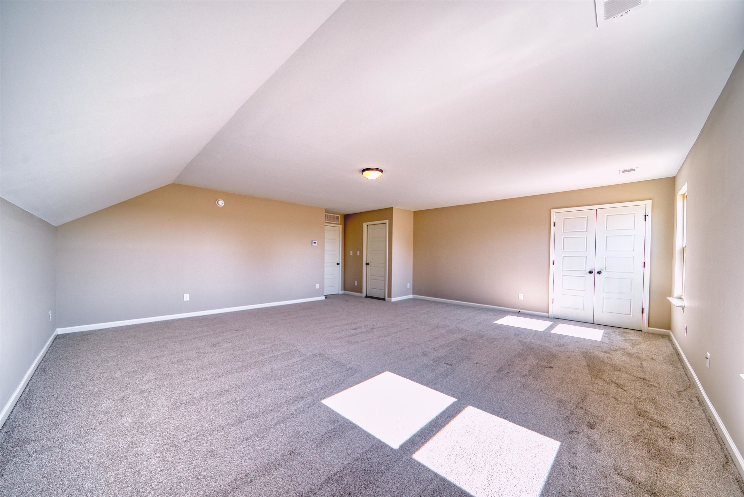 19 Columbia Way Atoka, TN 38004 - Photo 32 of 40 Additional living space with light colored carpet and vaulted ceiling
