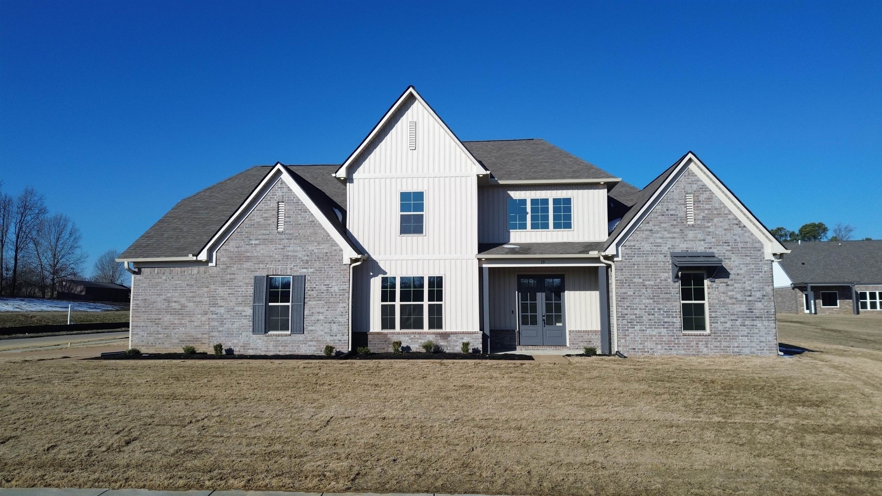 19 Columbia Way Atoka, TN 38004 - Photo 5 of 28 Back of property featuring a yard, french doors, brick siding, and board and batten siding