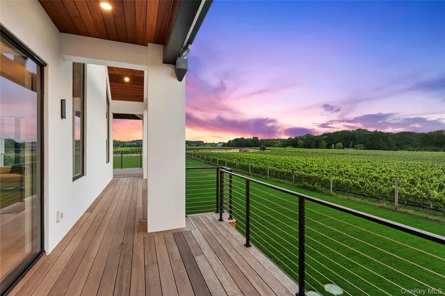 a view of balcony with wooden floor and fence