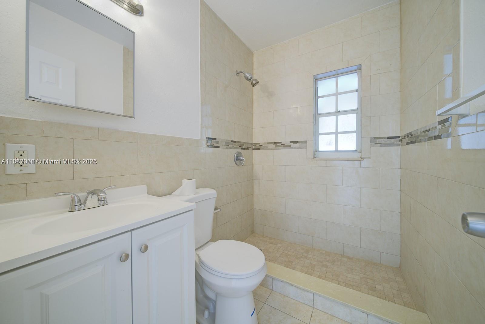 1471 Northwest 93rd Street Miami, FL 33147 - Photo 17 of 26 a bathroom with a sink toilet and shower