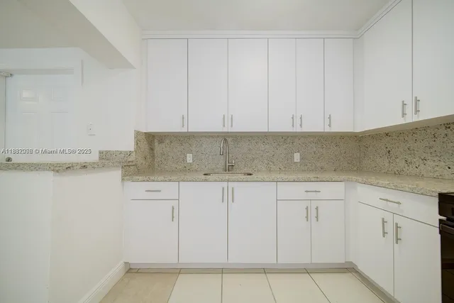 a front view of house with yard and trees around