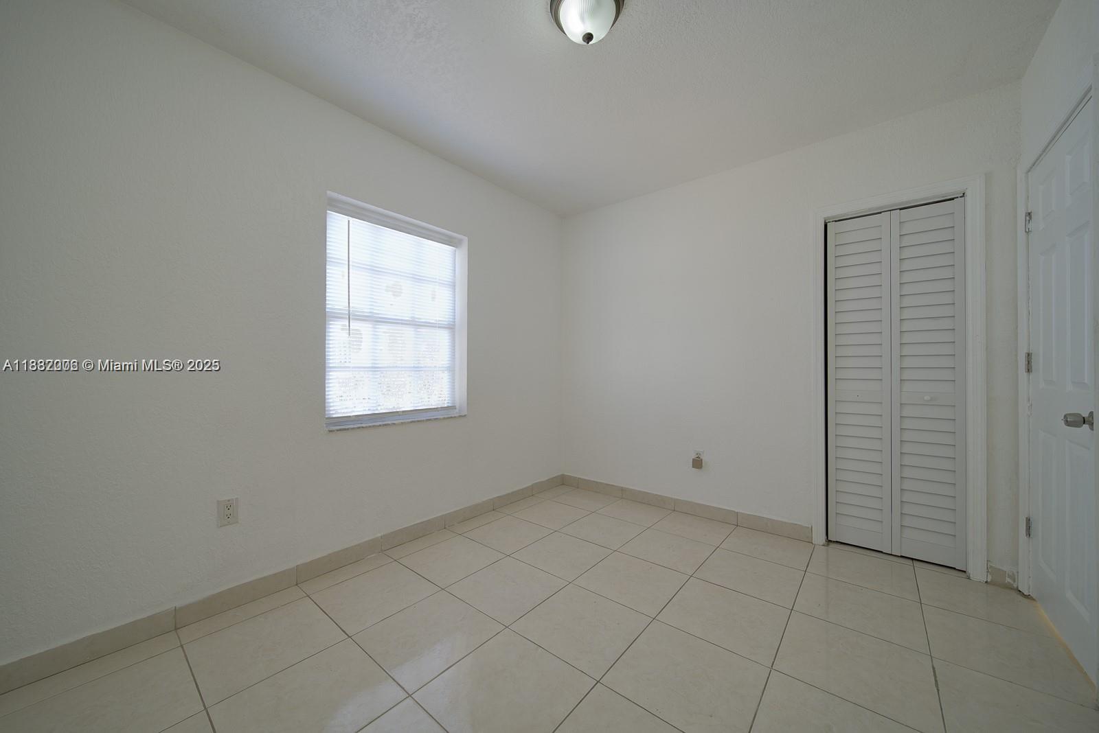 1471 Northwest 93rd Street Miami, FL 33147 - Photo 22 of 26 an empty room with windows