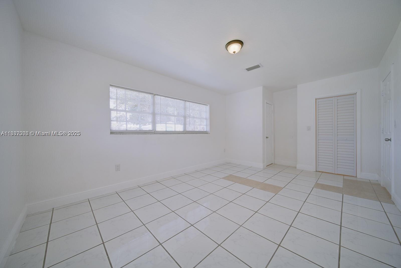1471 Northwest 93rd Street Miami, FL 33147 - Photo 25 of 26 a view of an empty room and window