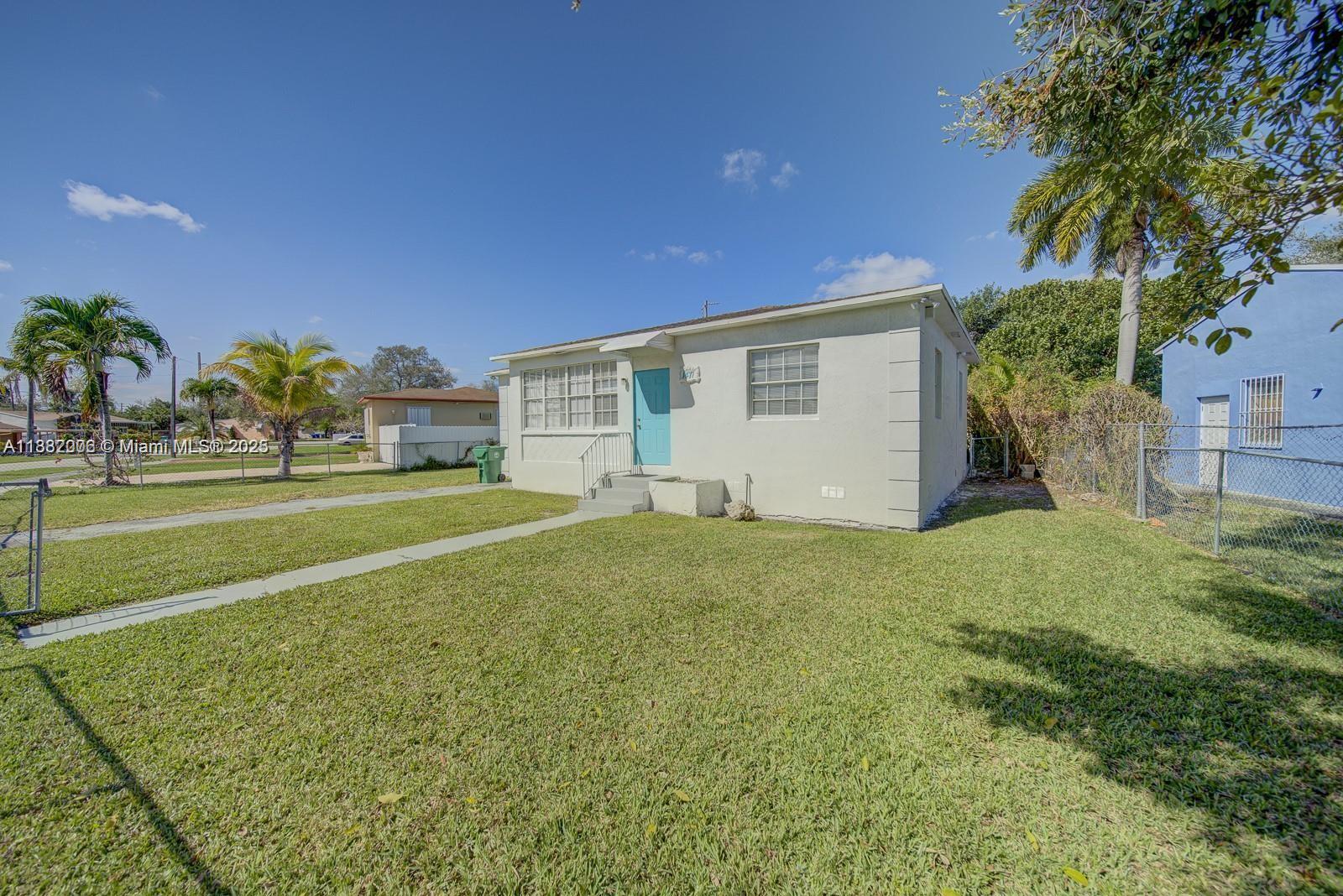 1471 Northwest 93rd Street Miami, FL 33147 - Photo 3 of 26 a view of a house with a backyard
