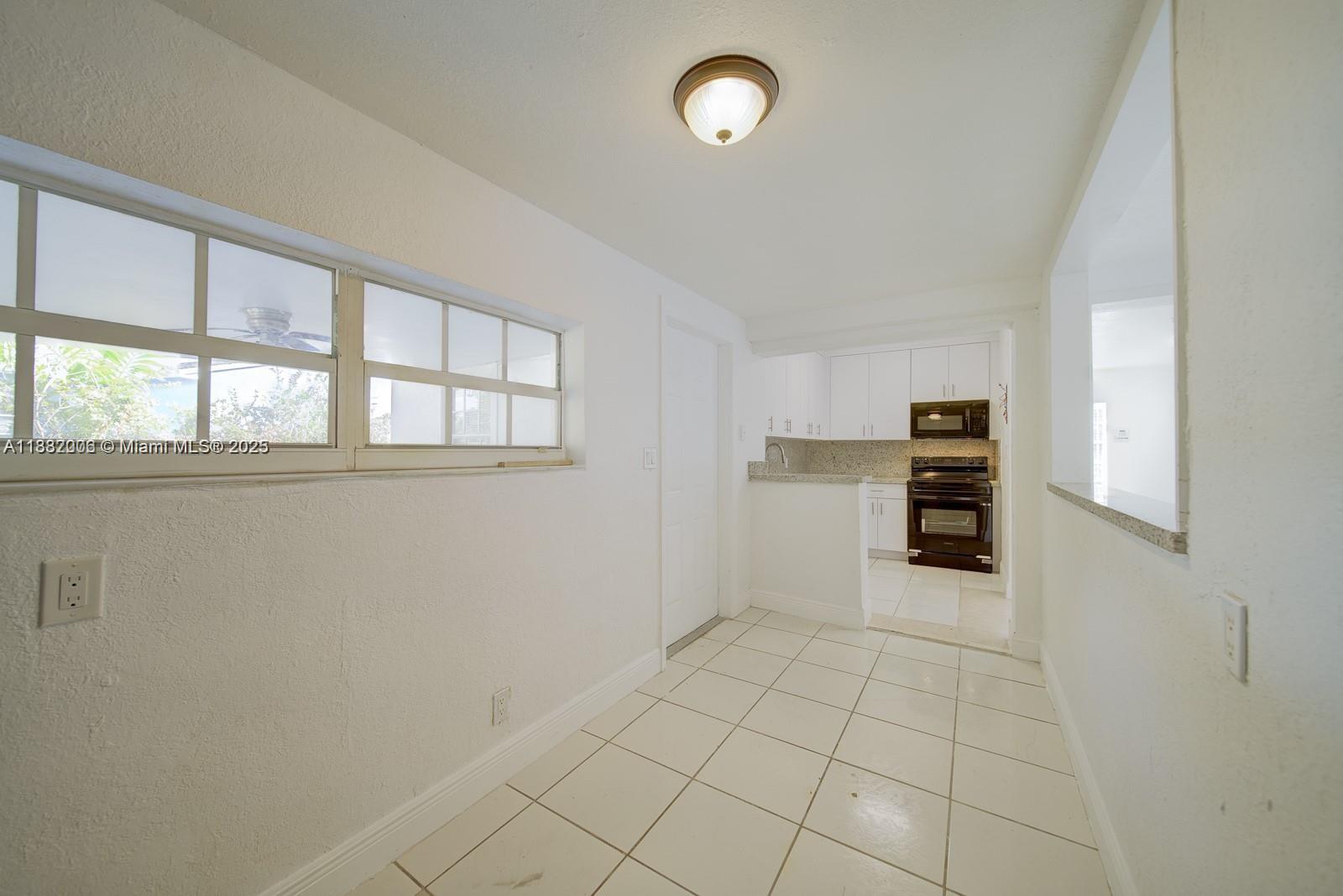 1471 Northwest 93rd Street Miami, FL 33147 - Photo 6 of 26 an empty room with windows