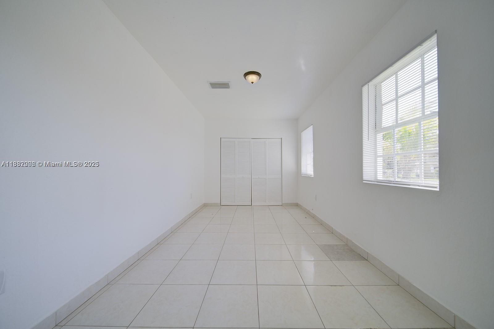 1471 Northwest 93rd Street Miami, FL 33147 - Photo 9 of 26 an empty room with windows