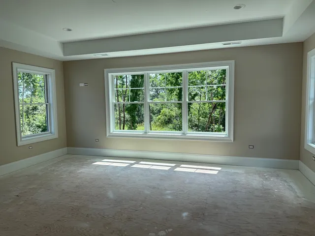 a spacious bathroom with double vanity a bathtub mirror and window