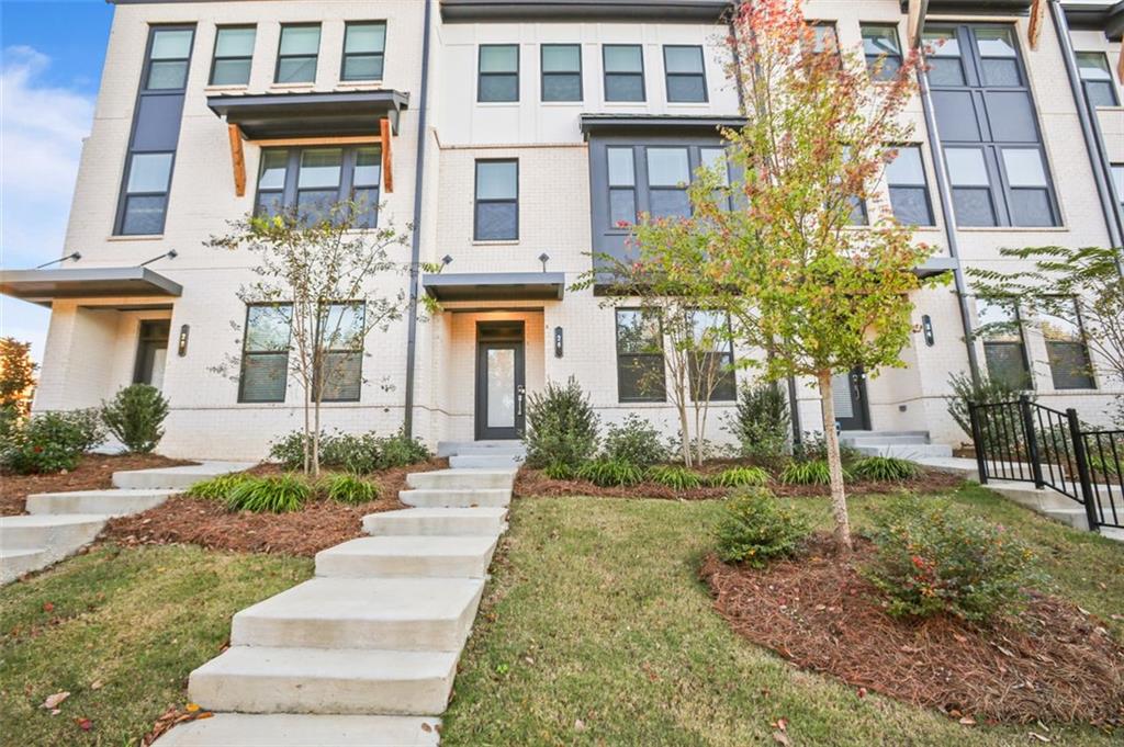 a view of a brick building next to a yard