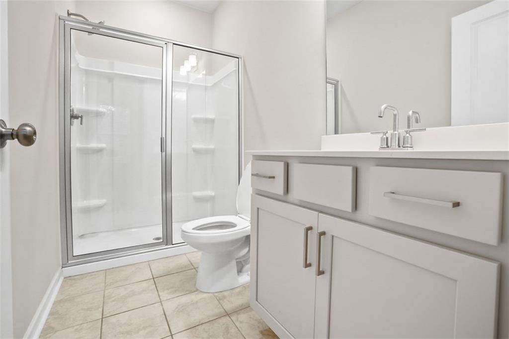 26 Peeples Drive Lawrenceville, GA 30046 - Photo 14 of 24 a bathroom with a sink a toilet and shower