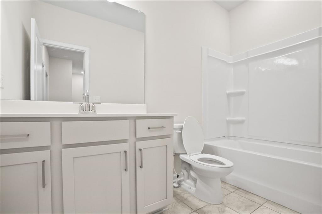 26 Peeples Drive Lawrenceville, GA 30046 - Photo 22 of 24 a bathroom with a sink toilet vanity and tub