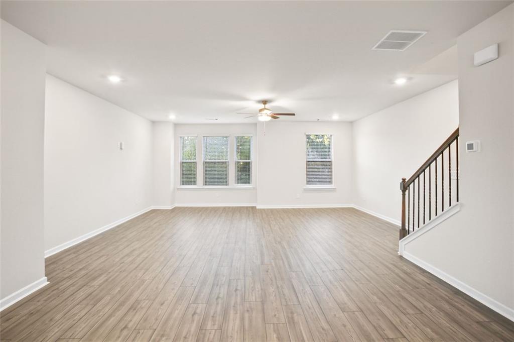 26 Peeples Drive Lawrenceville, GA 30046 - Photo 8 of 24 a view of an empty room with wooden floor and a window