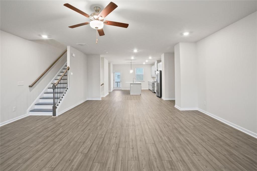 26 Peeples Drive Lawrenceville, GA 30046 - Photo 9 of 24 a view of an empty room with wooden floor and a ceiling fan