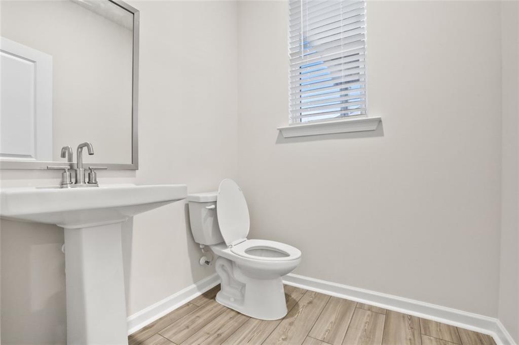26 Peeples Drive Lawrenceville, GA 30046 - Photo 10 of 24 a bathroom with a toilet and a sink